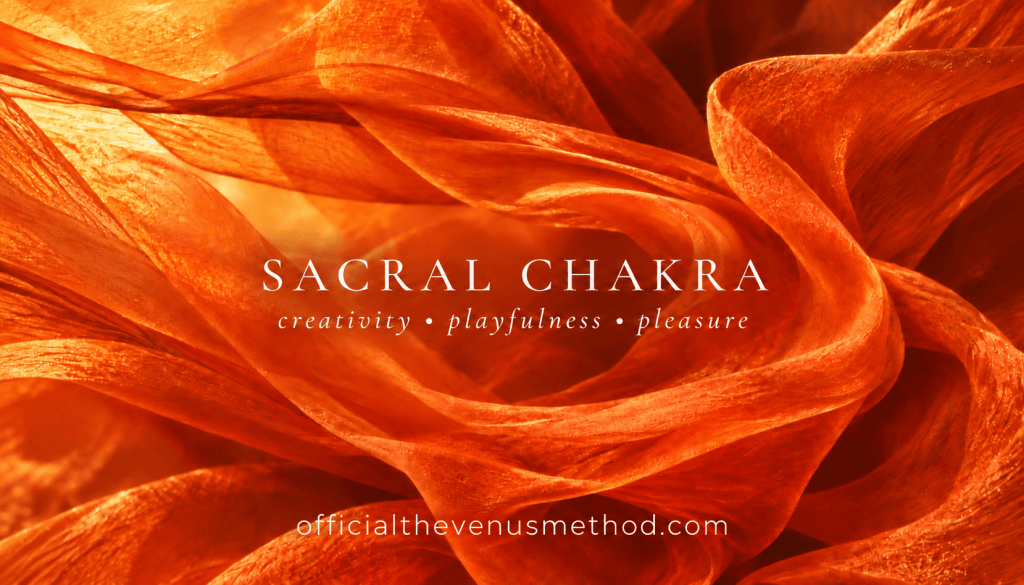 Flowing orange fabric with Sacral Chakra title and officialthevenusmethod.com